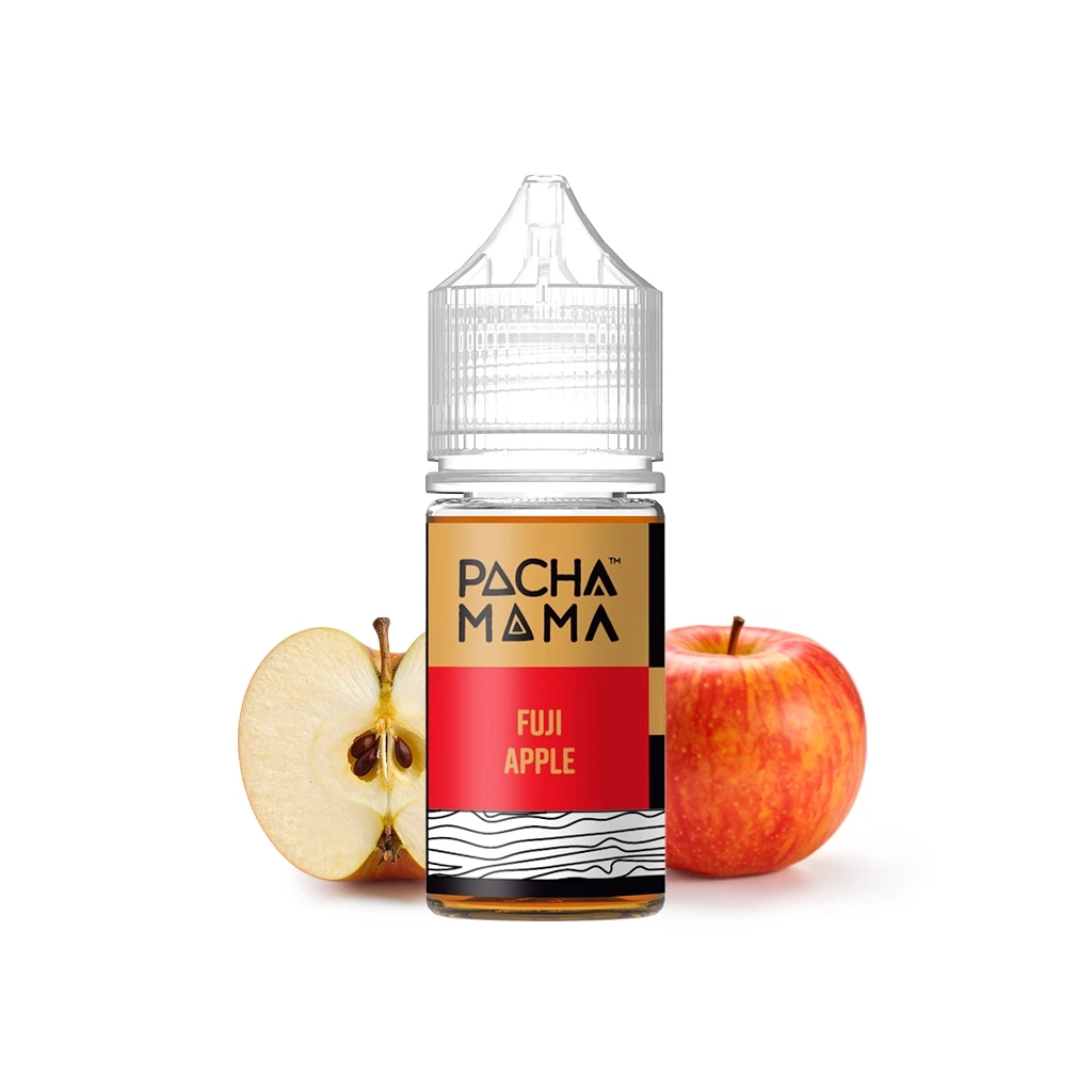 Frasco de Pachamama Fuji Apple con tapón transparente y etiqueta roja y dorada, delante de una manzana entera y otra cortada.