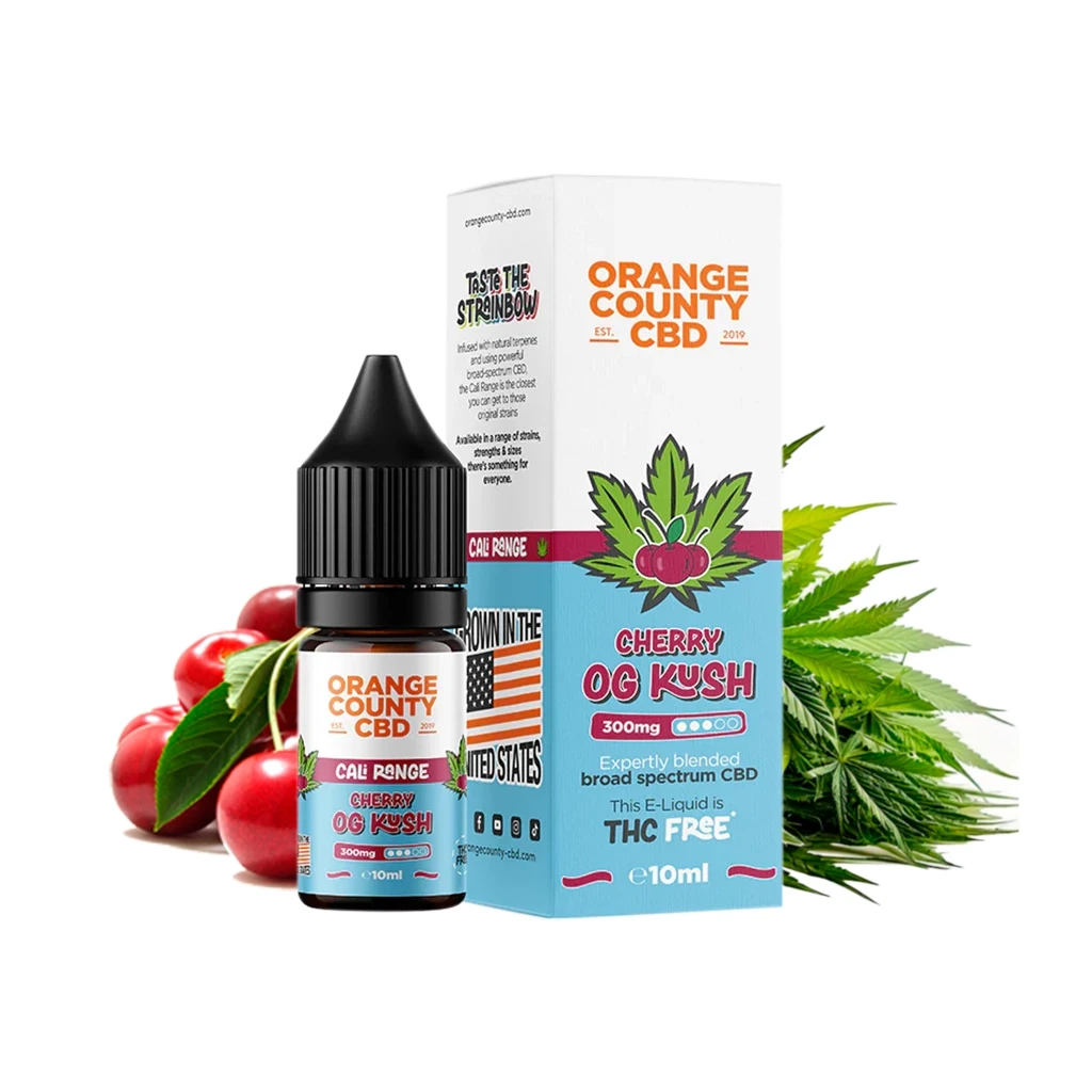 Frasco y caja de Orange County Cherry OG Kush de 10 ml, con etiqueta azul y blanca, junto a cerezas y hojas de cannabis.