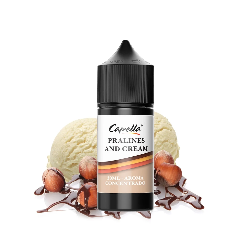Frasco negro de Pralines And Cream de Capella, con etiqueta de 30 ml, rodeado de helado, avellanas y salsa de chocolate.