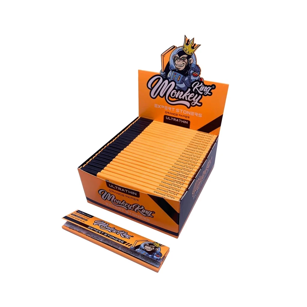 Expositor naranja de papel de fumar Orange KS Slim de Monkey King, con varios libritos y uno delante, decorado con un mono coronado.