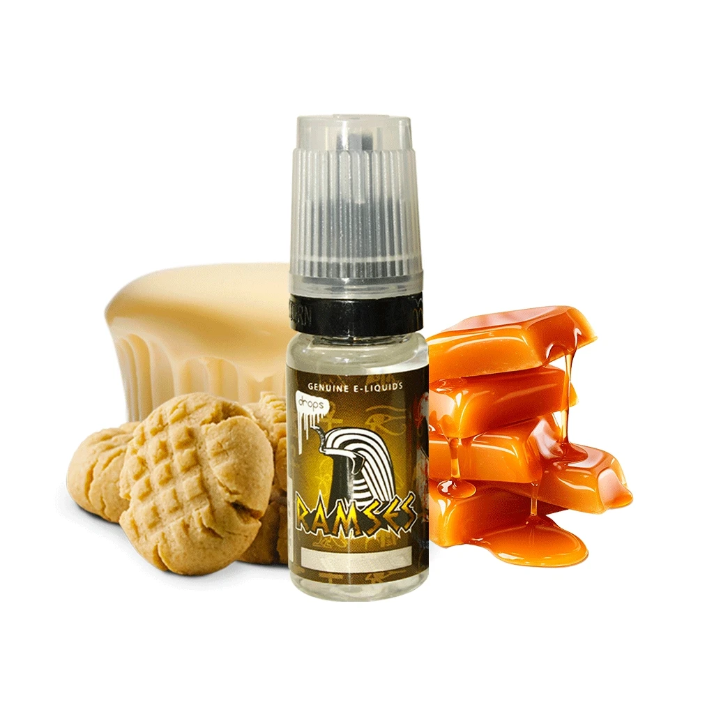 Frasco de líquido Drops Ramses con tapón translúcido, acompañado de galletas, un bloque amarillento y caramelos con caramelo fundido.