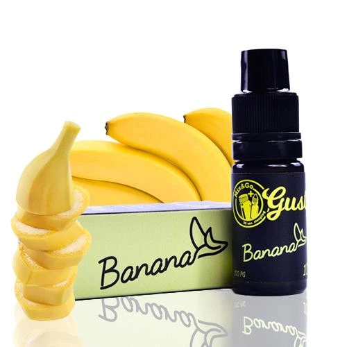 Frasco negro de aroma Gusto Banana con tapón negro junto a una caja verde clara, plátanos enteros y rodajas sobre fondo blanco.