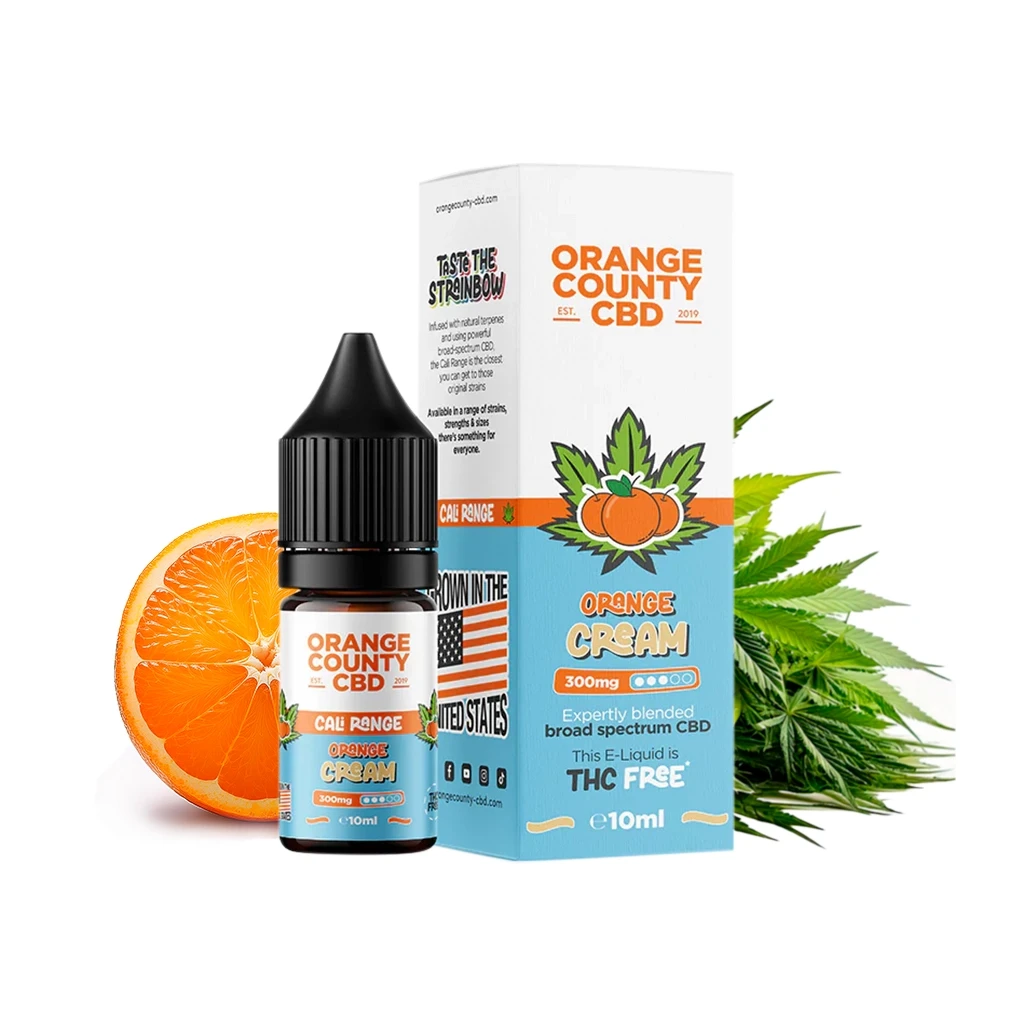 Frasco y caja de Orange County CBD Orange Cream de 10 ml, con etiquetas blancas y azules, media naranja y hojas verdes al fondo.