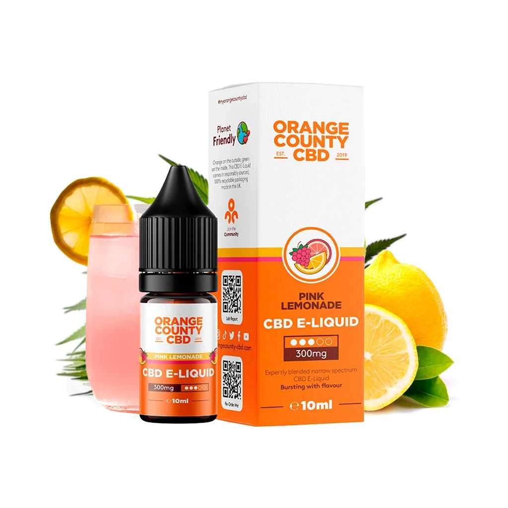 Frasco y caja de Orange County CBD E-liquid Pink Lemonade, etiquetados 300 mg y 10 ml, junto a limones y un vaso de bebida rosa.