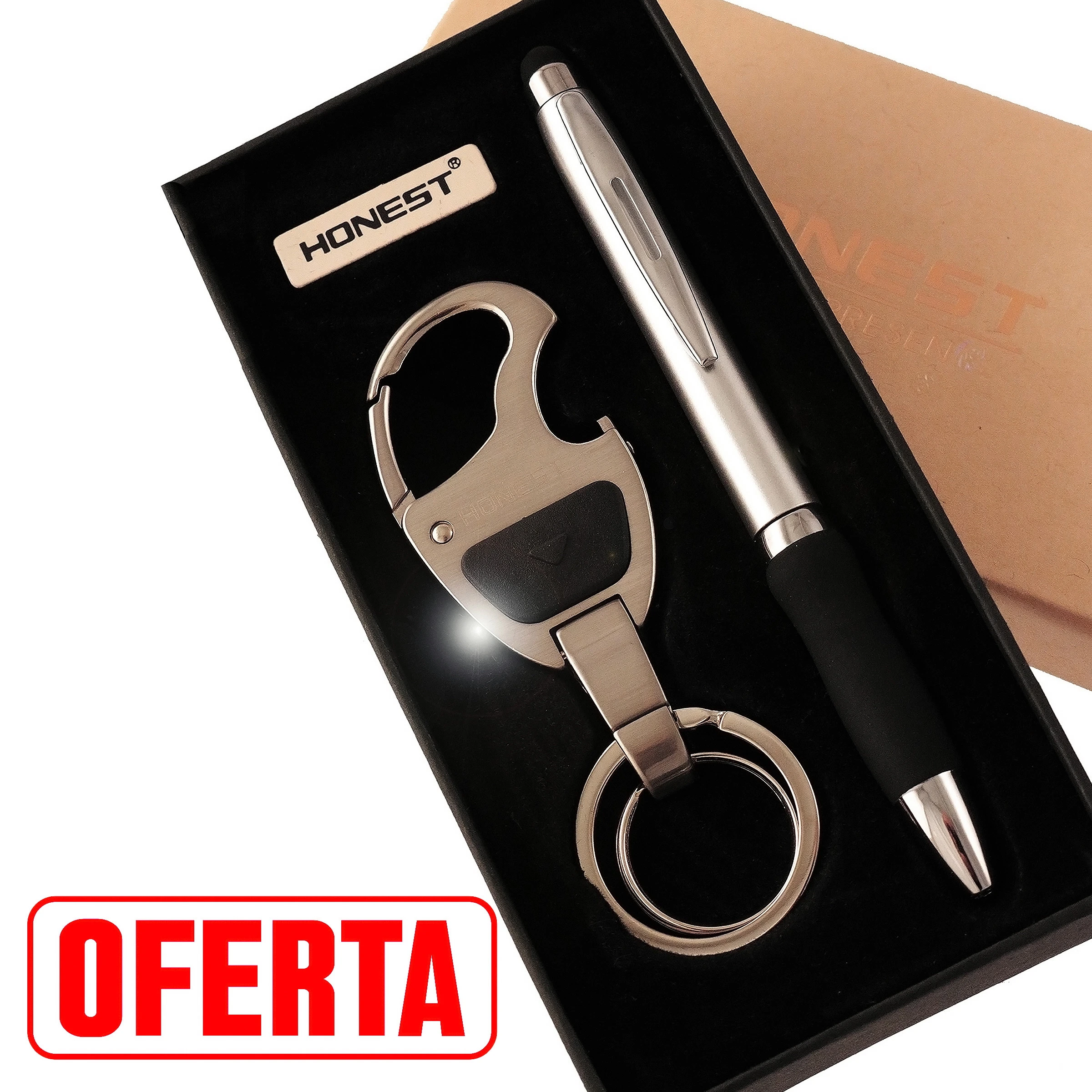 Estuche negro HONEST con bolígrafo plateado y negro y llavero metálico con abrebotellas, anillas y punto luminoso junto a la base.