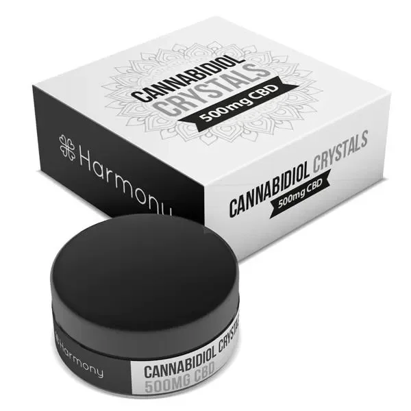 Tarro cerrado con tapa negra y caja Harmony Pure CBD Crystals, ambos con etiquetas que indican 500 mg de CBD, sobre fondo blanco.
