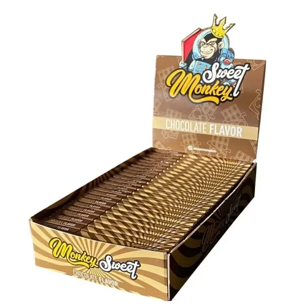 Expositor abierto de papel Monkey King sabor chocolate, con librillos marrones y dorados y un mono coronado en la cabecera.