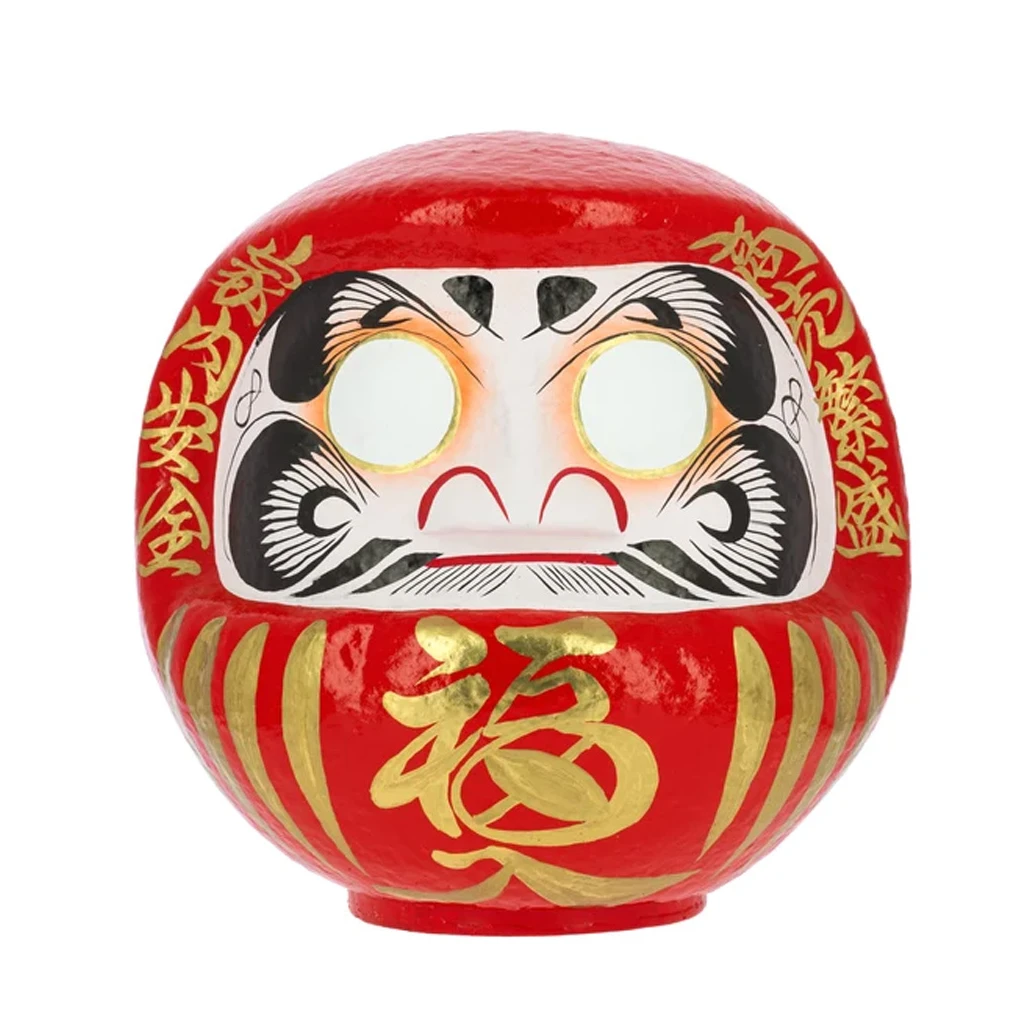 Daruma tradicional rojo de frente, con ojos blancos sin pupilas, cejas y bigote negros e inscripciones doradas. Daruma tradicional rojo de frente, con ojos blancos sin pupilas, cejas y bigote negros e inscripciones doradas.