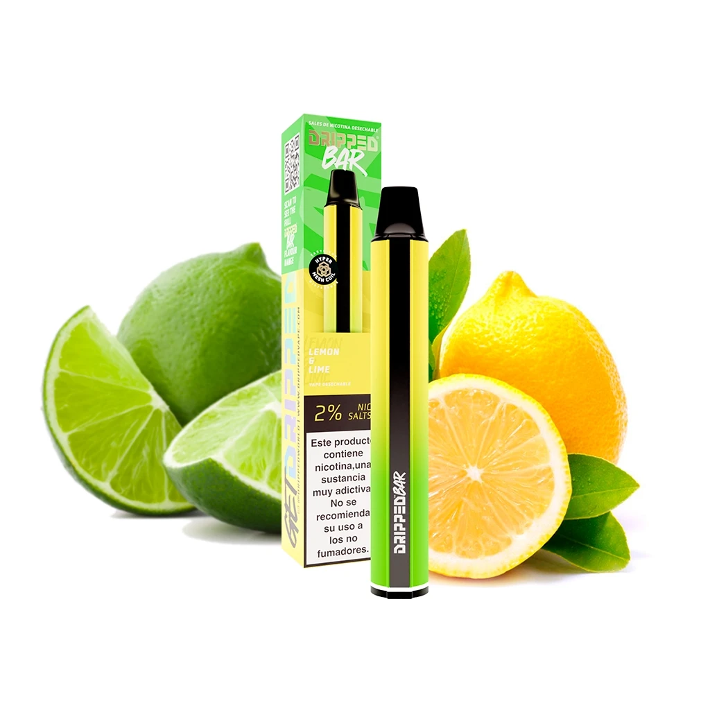 Vaper Dripped Bar Lemon Lime verde y amarillo junto a su caja, con boquilla negra y limones y limas enteros y cortados al fondo.
