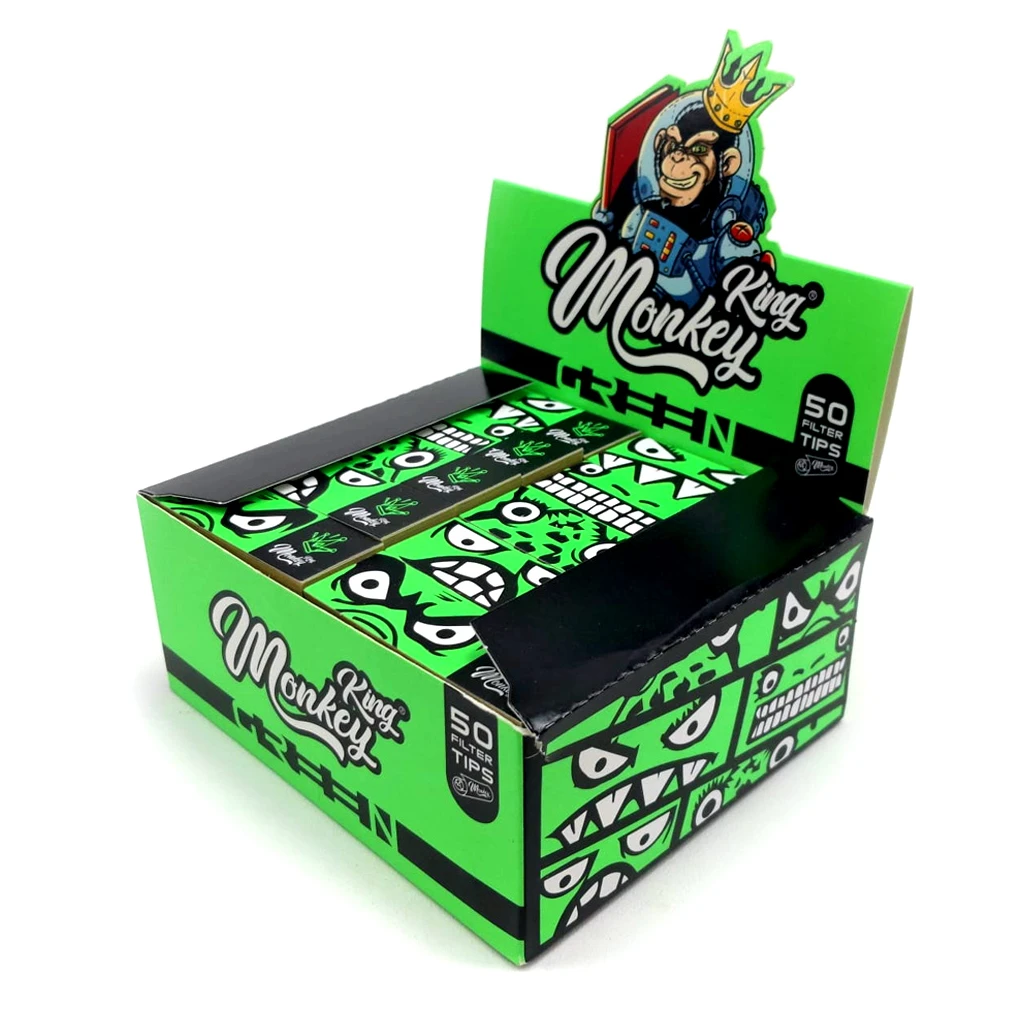 Caja expositora abierta de filtros Monkey King Green, verde y negra, con libritos decorados con caras y un mono coronado en la cabecera.