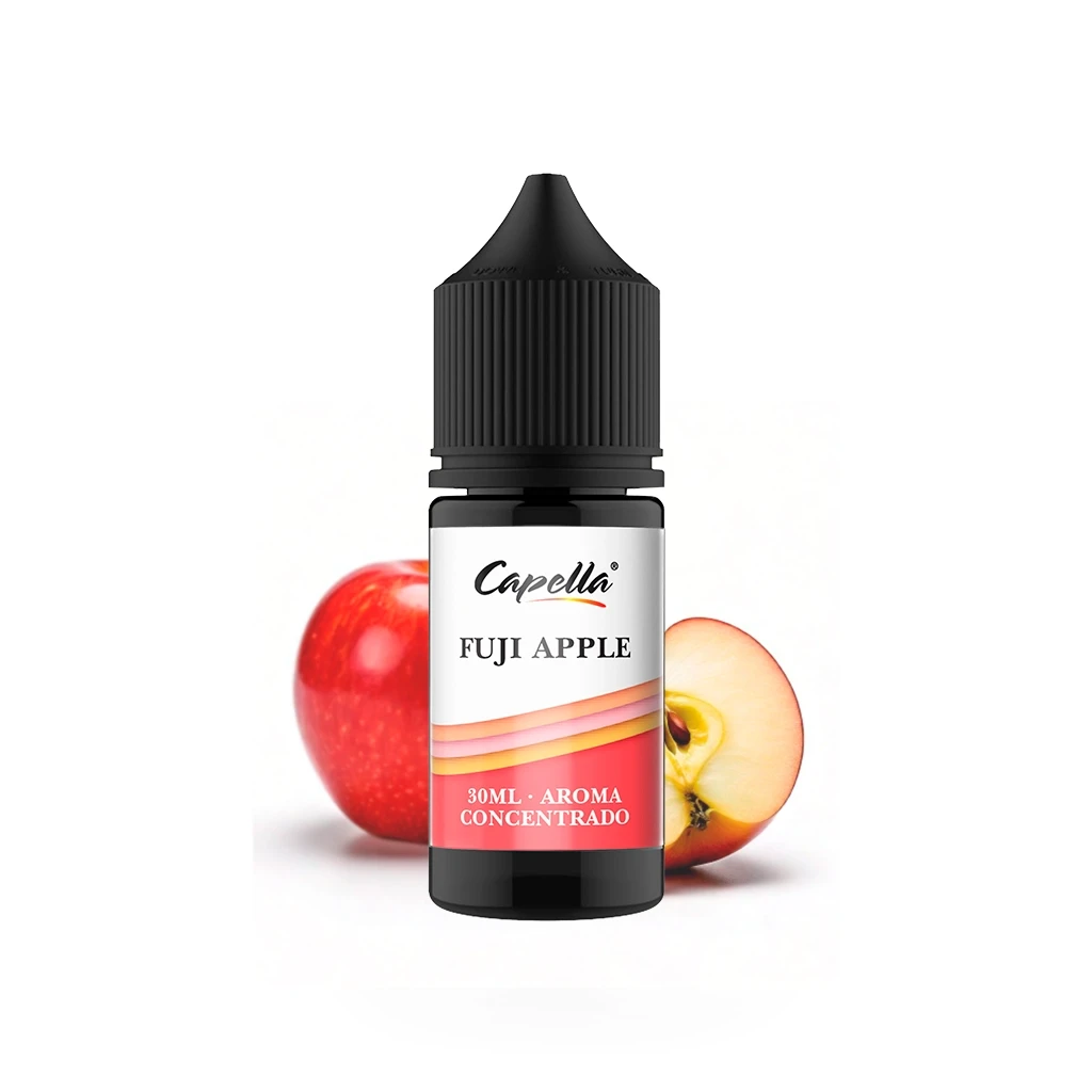 Frasco negro de aroma concentrado Capella Fuji Apple, con etiqueta de 30 ml, delante de una manzana roja y otra cortada.