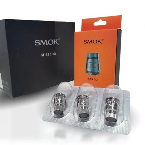 Resistencias metálicas SMOK en un blíster transparente, delante de cajas negra y naranja con la indicación B2 de 0,3 ohmios.