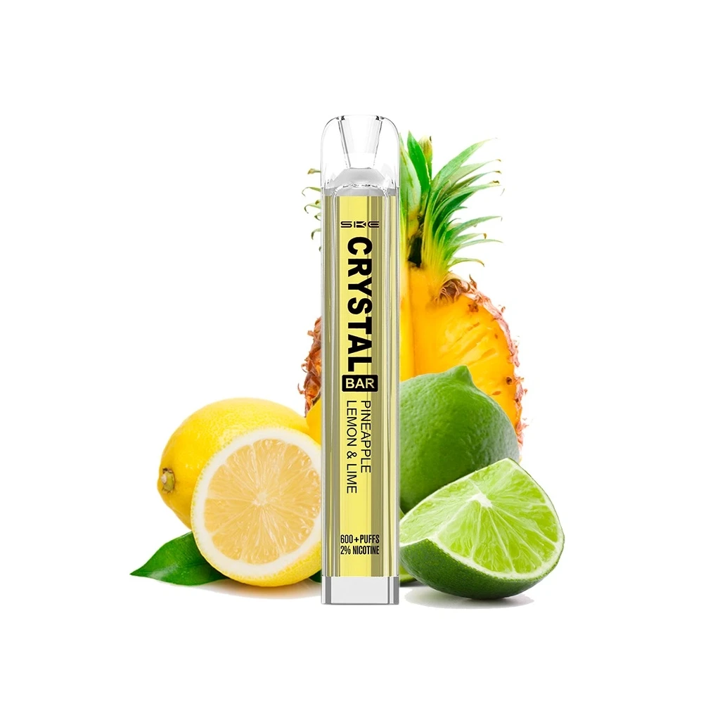 Vaper SKE Crystal Bar Pineapple Lemon & Lime con carcasa transparente y etiqueta amarilla, delante de piña, limón y lima cortados.