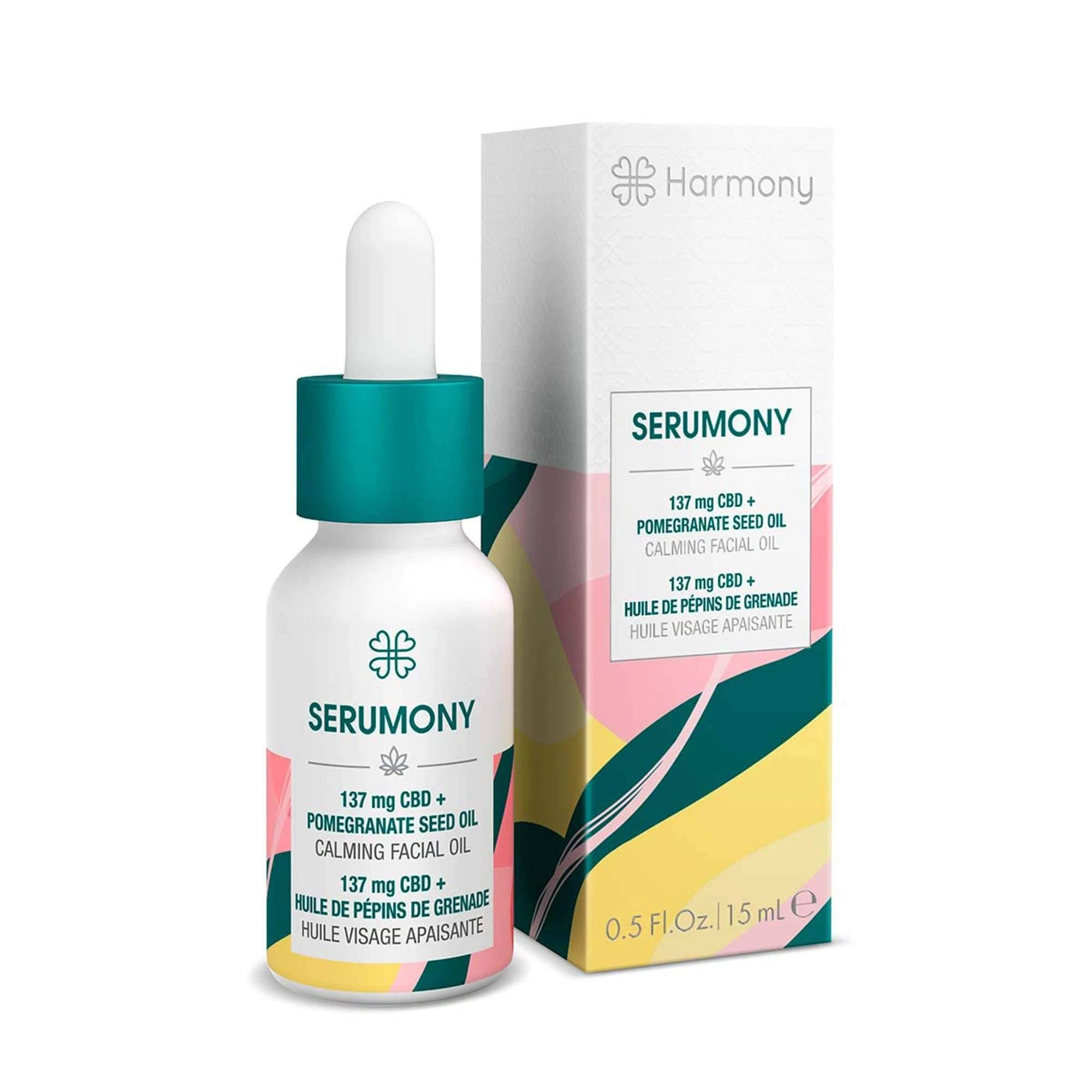 Aceite facial SERUMONY de Harmony en frasco blanco con cuentagotas y tapón verde, junto a su caja con franjas rosas, verdes y amarillas.