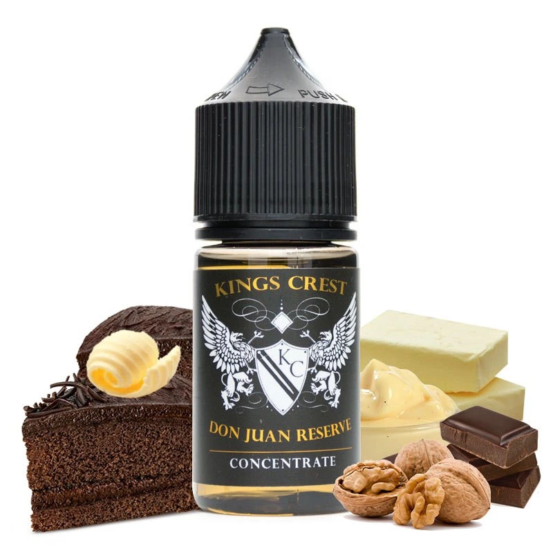 Frasco de concentrado King's Crest Don Juan Reserve con tapón negro, rodeado de tarta de chocolate, mantequilla, chocolate y nueces.