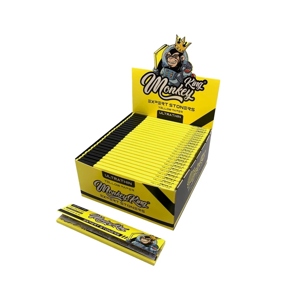 Expositor amarillo y negro de papel de fumar Monkey King Yellow KS Slim, con varios librillos y un mono coronado en la cabecera.