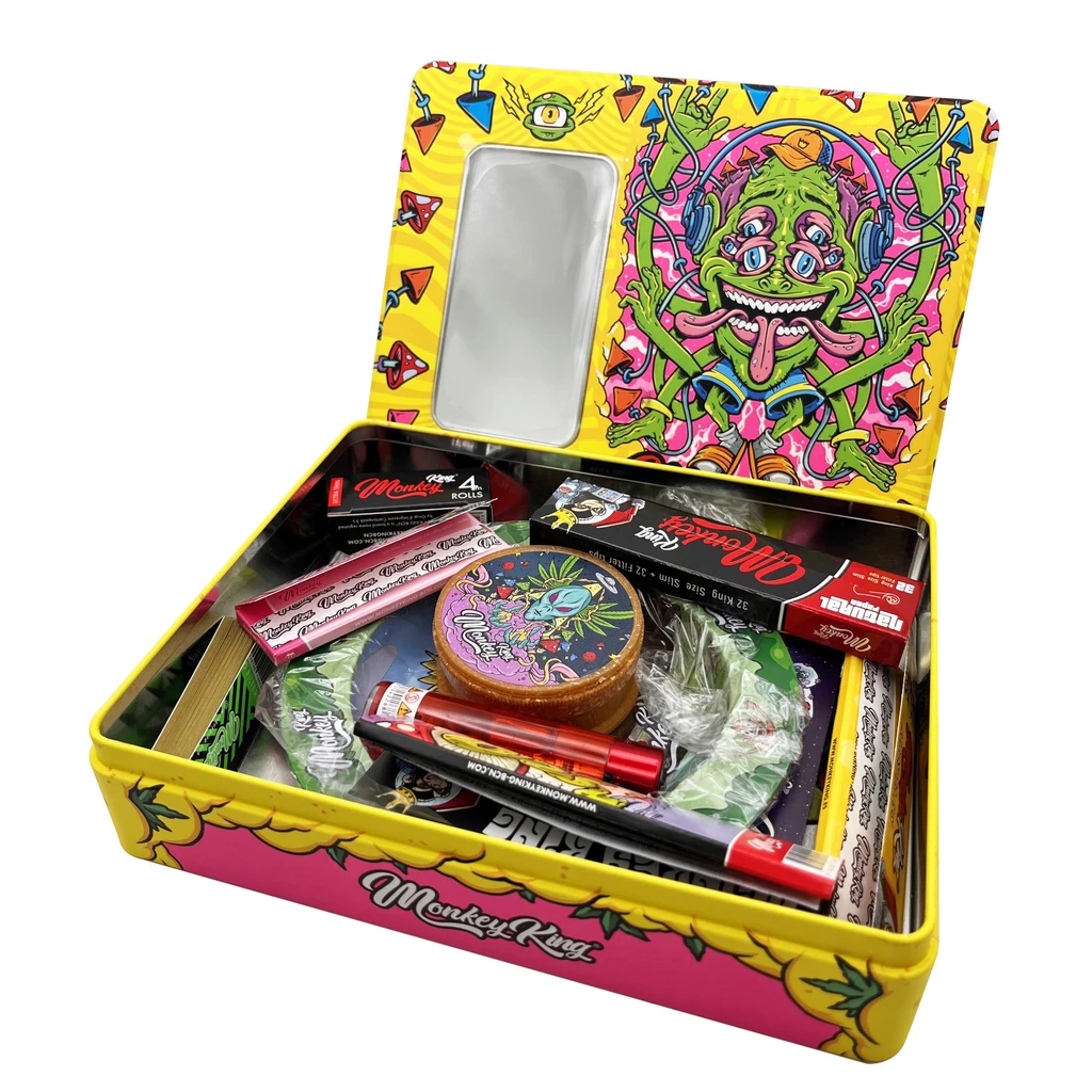 Kit de liar Monkey King en caja abierta amarilla y rosa, con espejo en la tapa, ilustración de un mono y accesorios en el interior.