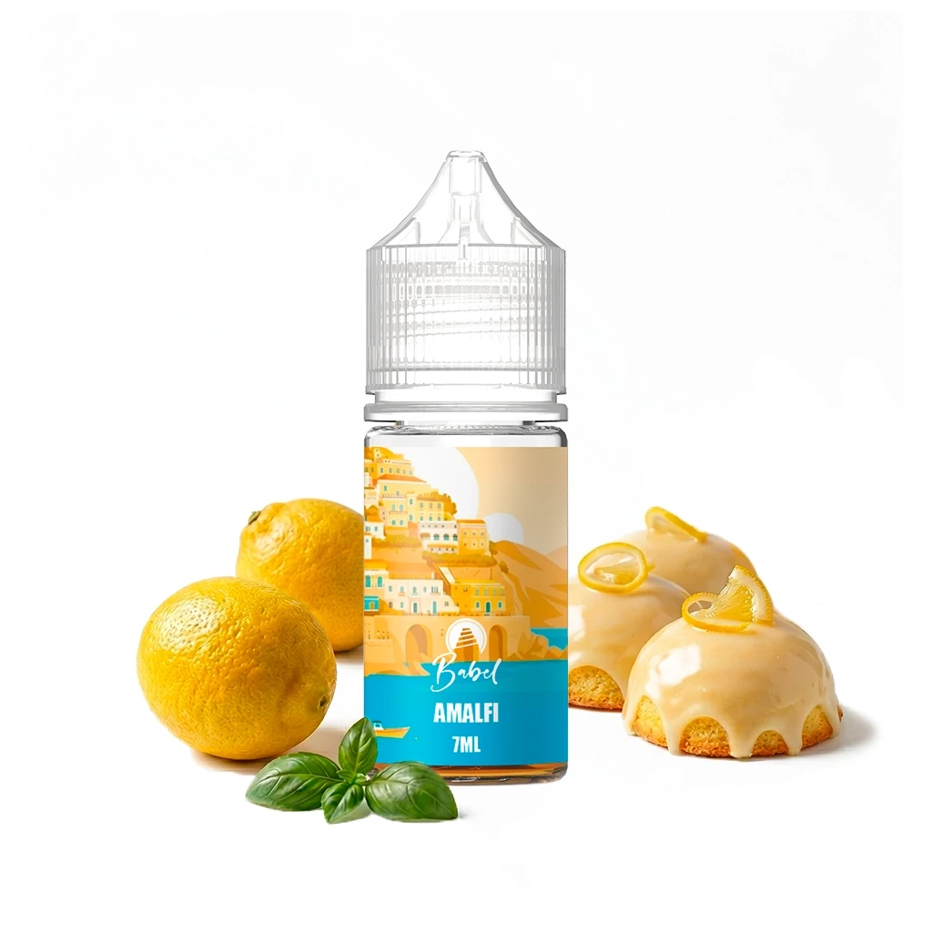 Frasco Babel Amalfi de 7 ml con tapón transparente, rodeado de limones, hojas verdes y pequeños pasteles glaseados sobre fondo blanco.