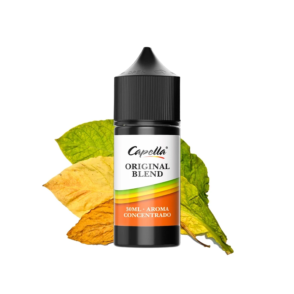 Frasco negro de aroma Capella Original Blend de 30 ml, con tapón estriado y etiqueta blanca y naranja, delante de hojas verdes y amarillas.