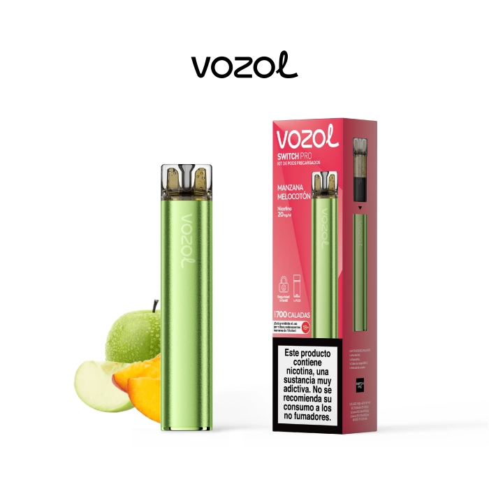 Vozol Switch Pro verde junto a su caja roja de Manzana Melocotón, con advertencia de nicotina y frutas al fondo.