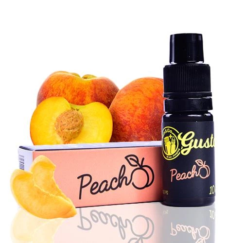 Frasco negro de aroma Mix&Go Peach junto a su caja rosada, con melocotones enteros, una mitad con hueso y una rodaja.