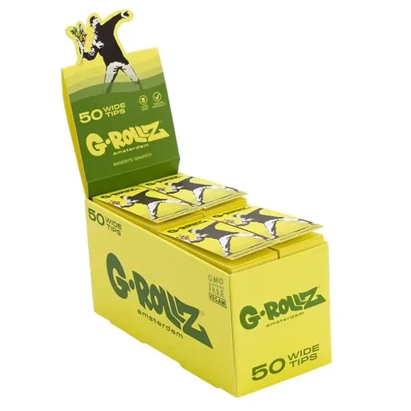 Expositor amarillo de filtros G-Rollz Wide con varios libritos y la figura de un hombre lanzando flores en las cubiertas.
