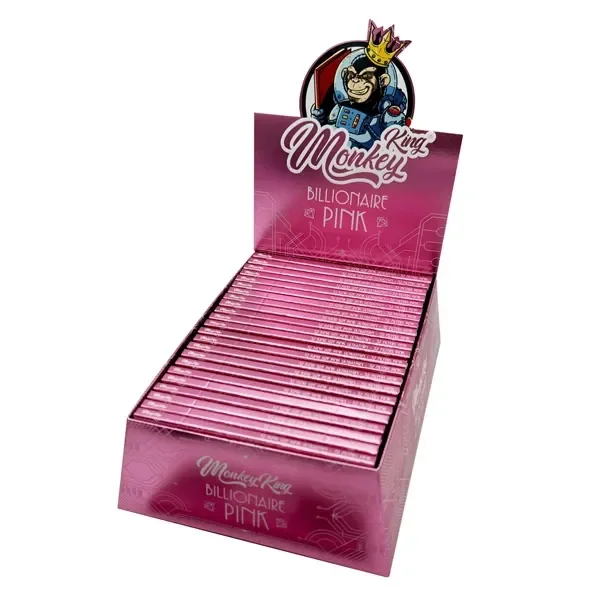 Expositor rosa de papel Monkey King Billionaire Pink con varias libretas alineadas y un cartel con un mono coronado vestido de astronauta.