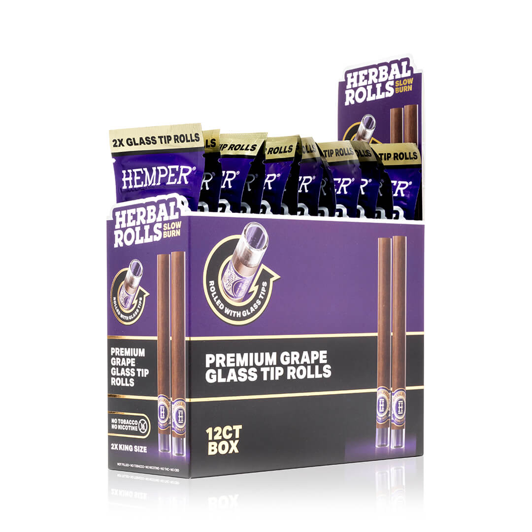 Expositor morado HEMPER Herbal Rolls Grape con varios sobres y dibujos de conos marrones con boquillas de vidrio; indica King Size.