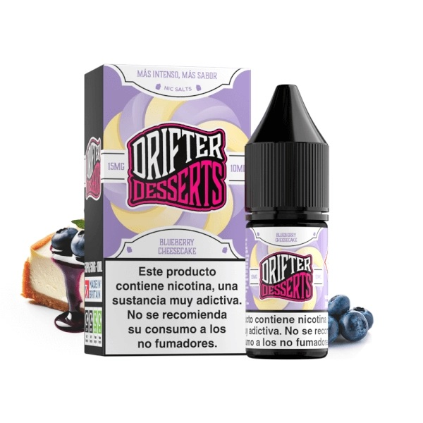 Caja y frasco de Drifter Desserts Salts Blueberry Cheesecake, con etiqueta lila y aviso de nicotina, junto a arándanos y tarta.