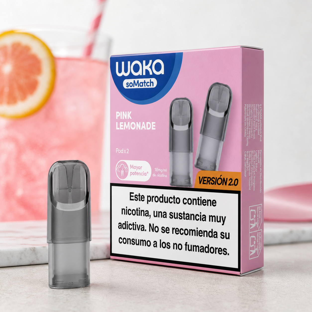 Cartucho Waka junto a su caja rosa Pink Lemonade versión 2.0, con advertencia sobre nicotina y una bebida rosa al fondo.