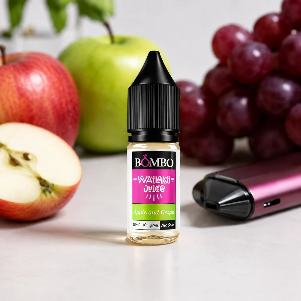 Frasco de Wailani Juice Apple & Grape de Bombo con tapón negro, entre manzanas y uvas, junto a un vapeador rosa.