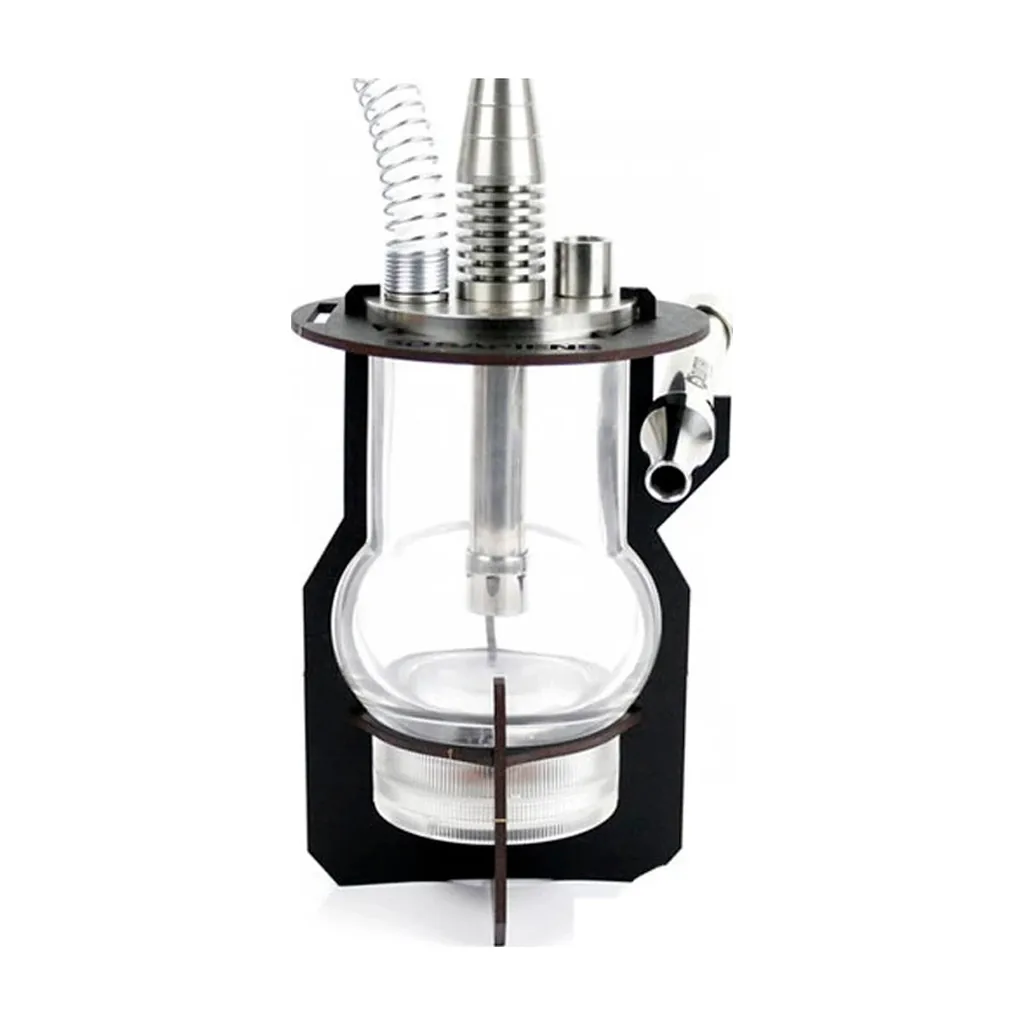 Soporte negro para Oduman Micro rodeando un recipiente transparente, con piezas metálicas superiores y conexión lateral. Soporte negro para Oduman Micro rodeando un recipiente transparente, con piezas metálicas superiores y conexión lateral.