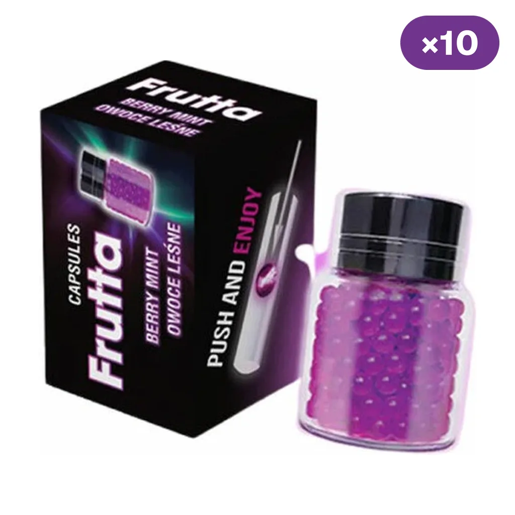 Caja negra Frutta Berry Mint junto a un frasco transparente con cápsulas moradas y tapón negro; distintivo «×10» en la esquina.