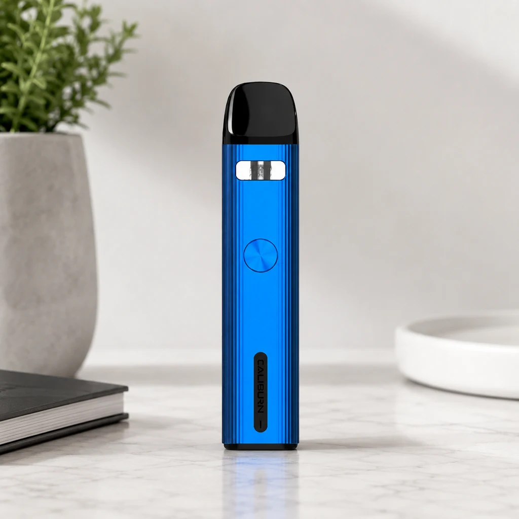 Uwell Caliburn G2 azul en posición vertical, con boquilla negra, ventana superior y botón circular, sobre una superficie clara.