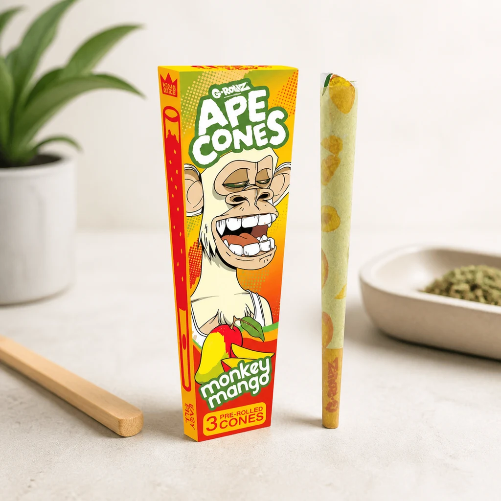 Caja de conos G-Rollz APE Monkey Mango con un mono ilustrado, junto a un cono decorado con mangos sobre una mesa clara.