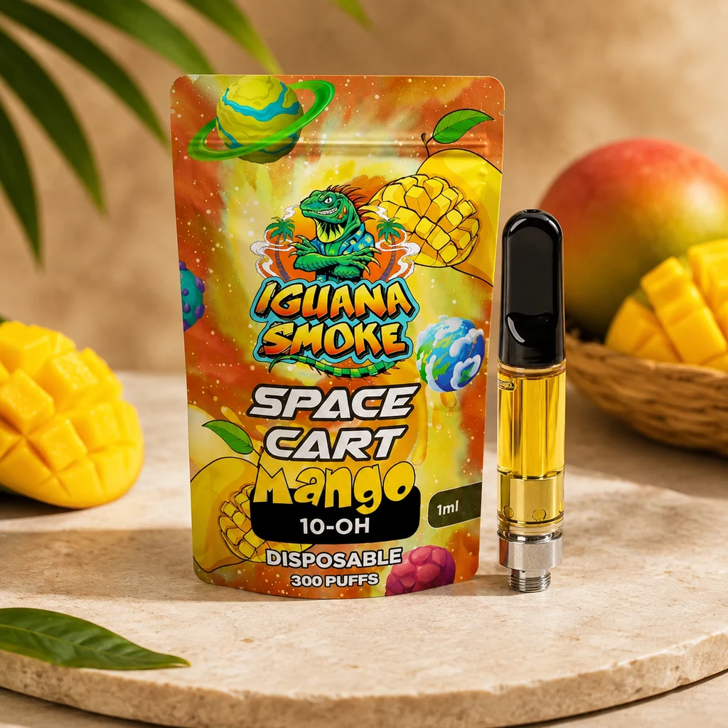 Cartucho con líquido amarillo y boquilla negra junto a un envase Iguana Smoke Space Cart Mango 10-OH, con mangos alrededor.
