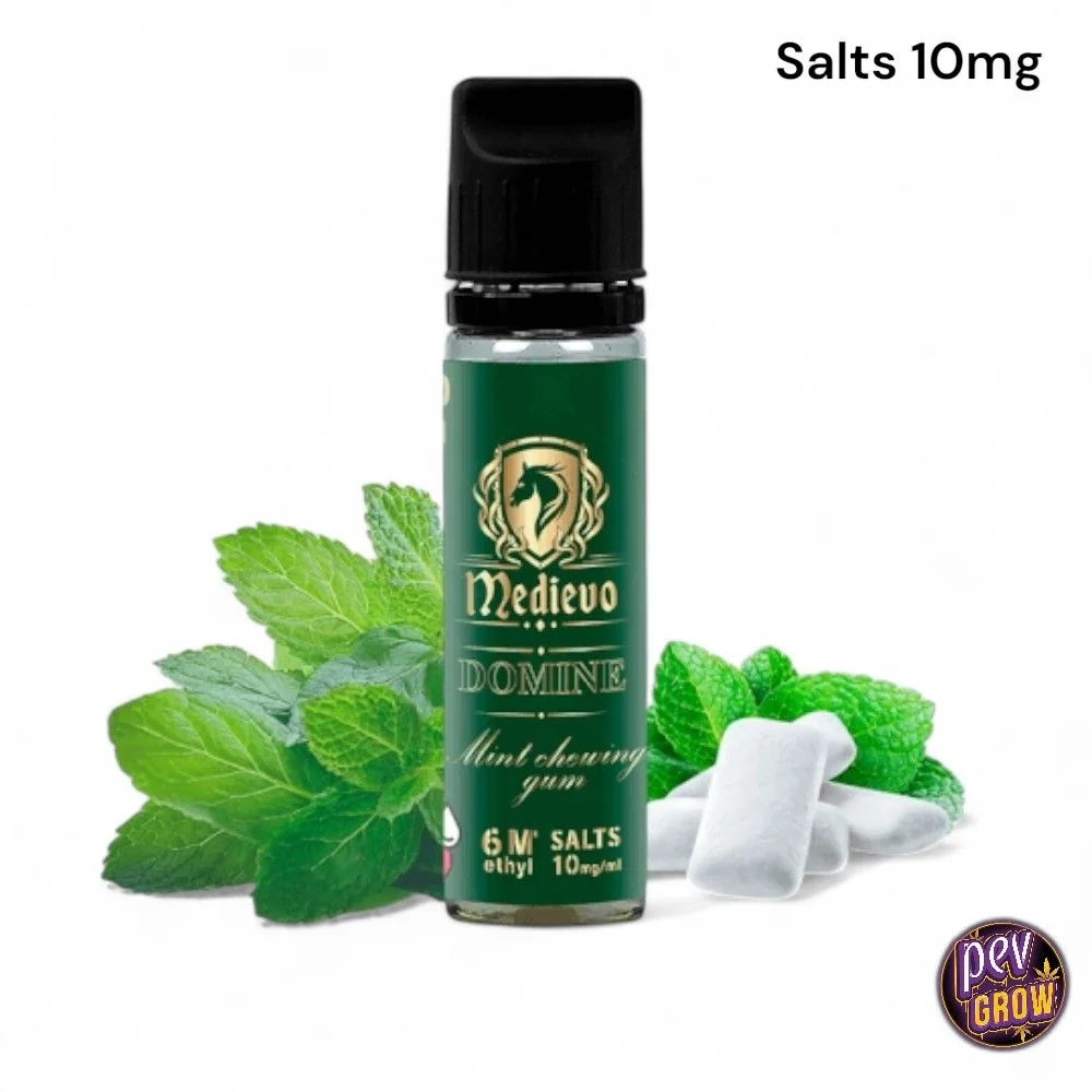 Frasco Medievo Domine de etiqueta verde y tapón negro, junto a hojas de menta y chicles blancos, con el texto «Salts 10mg».