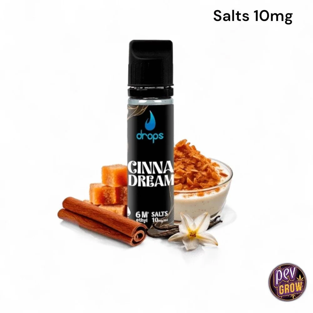 Frasco de Drops Cinnadream con etiqueta negra, junto a canela, vainilla y un cuenco de crema; texto superior «Salts 10mg».