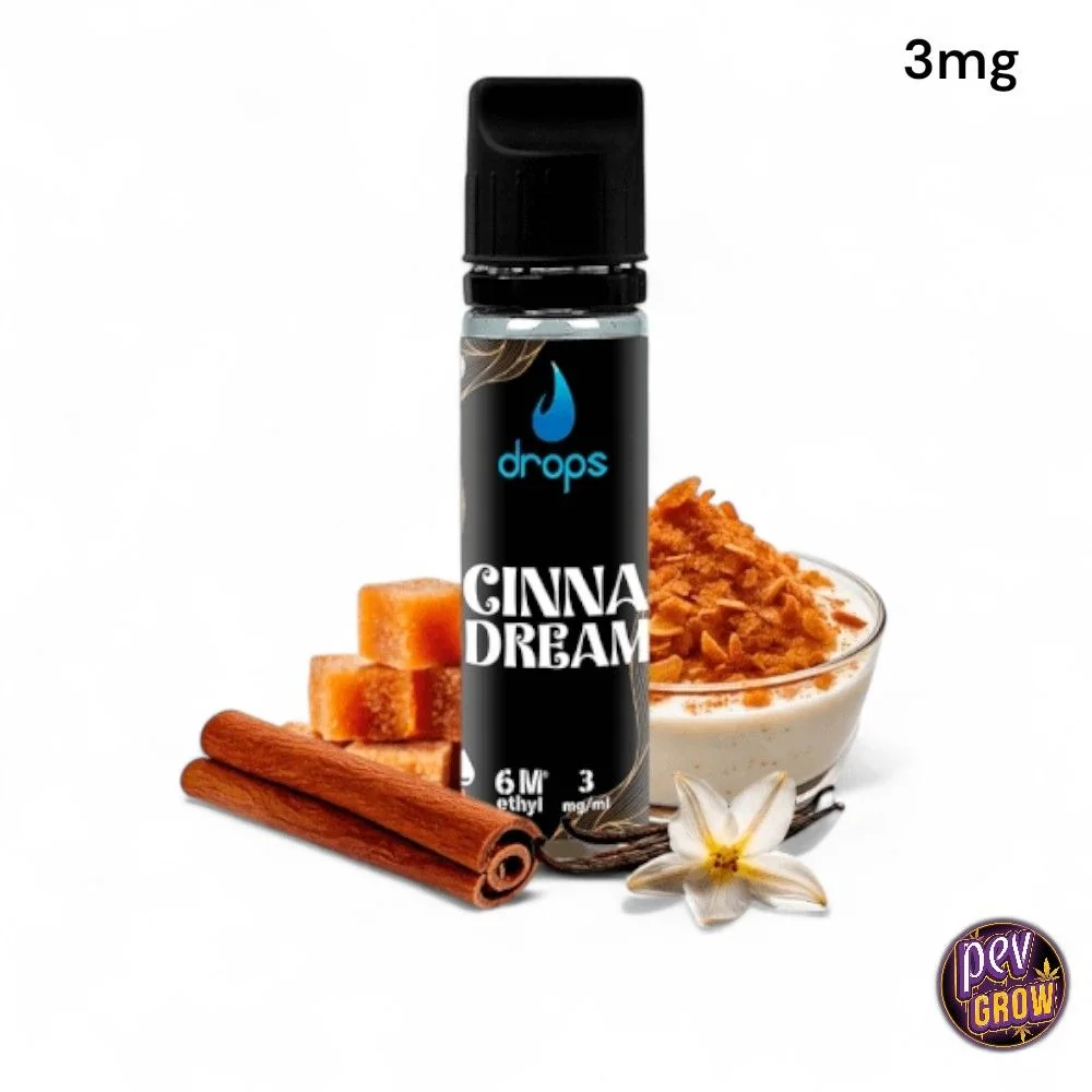 Frasco de e-líquido Drops Cinnadream con indicación de 3 mg/ml, rodeado de canela, terrones y un cuenco con crema y copos.