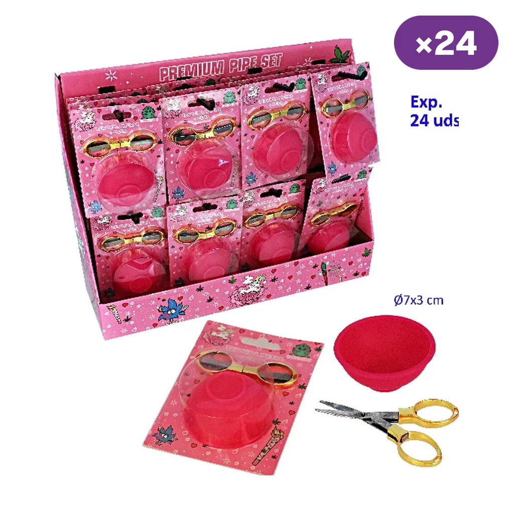 Expositor de blísteres rosas con cuenco de silicona y tijeras de asas doradas, con un blíster y los accesorios separados delante.