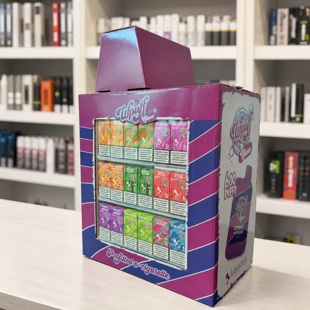 Expositor Wpuff Nano de Liquideo en tonos fucsia y azul, con cajas de distintos colores distribuidas en tres filas sobre un mostrador.