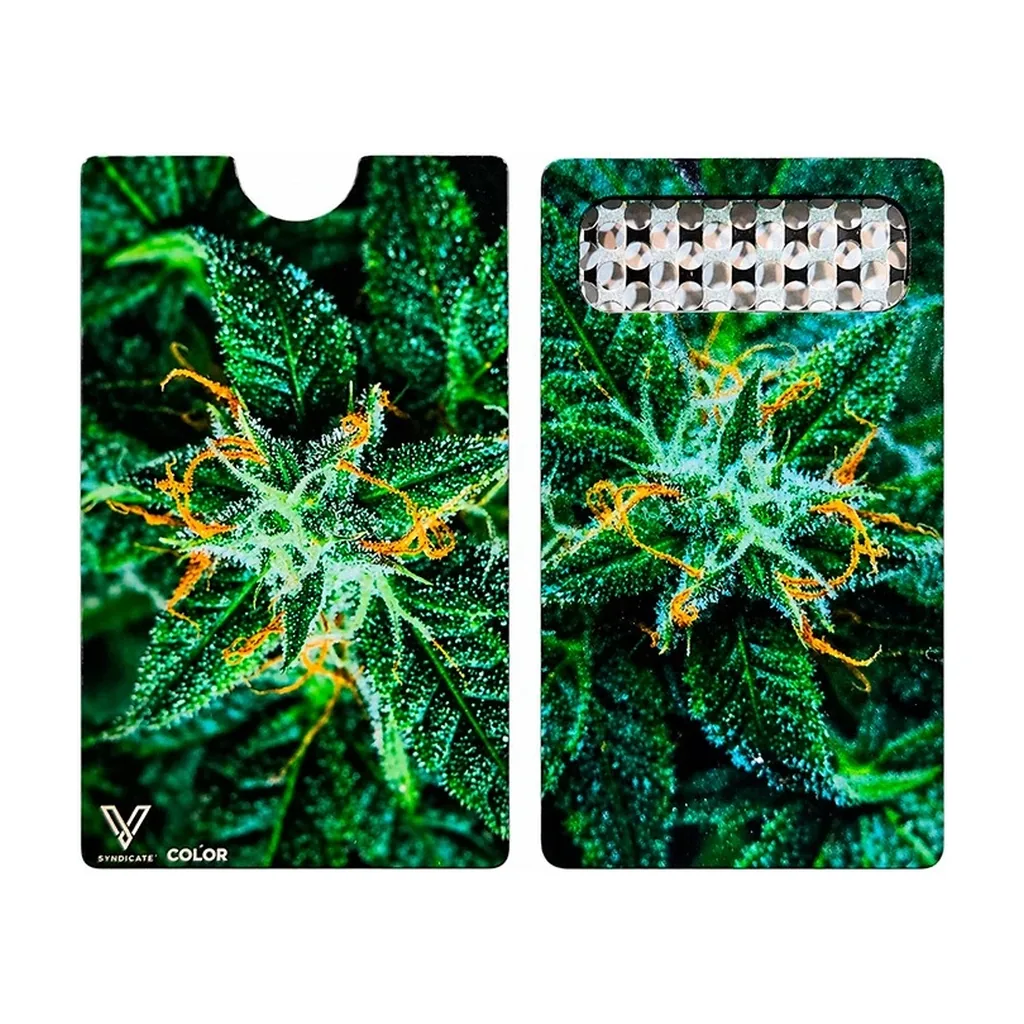 Grinder tarjeta AK-47 mostrado por ambas caras, con estampado de flores verdes y pistilos naranjas y zona ralladora rectangular.