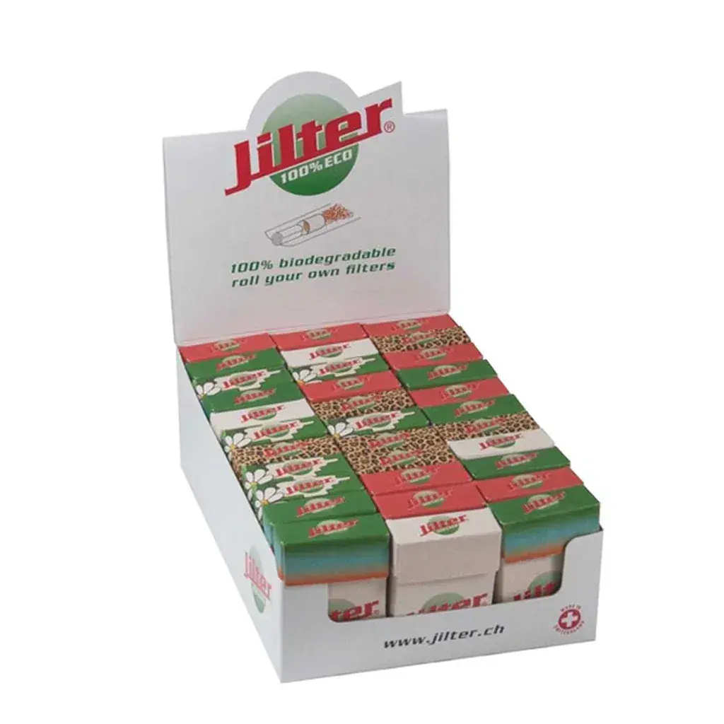 Expositor blanco de filtros Jilter Eco con pequeñas cajas de diseños verdes, rojos y blancos, visto en perspectiva.