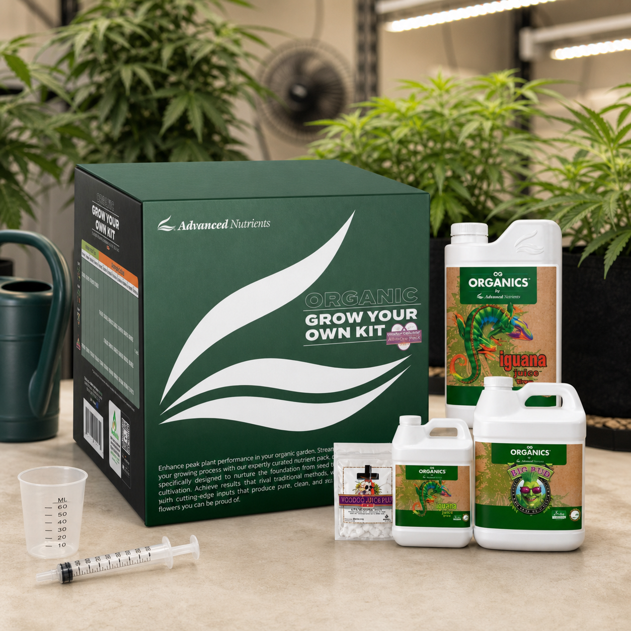 Kit orgánico de Advanced Nutrients con caja verde, envases, sobre, vaso medidor y jeringa, ante plantas de cannabis bajo luces de cultivo.