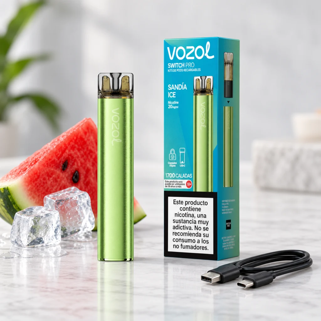 Vozol Switch Pro Watermelon Ice verde junto a su caja, un cable USB, sandía cortada y cubitos de hielo sobre una superficie clara.