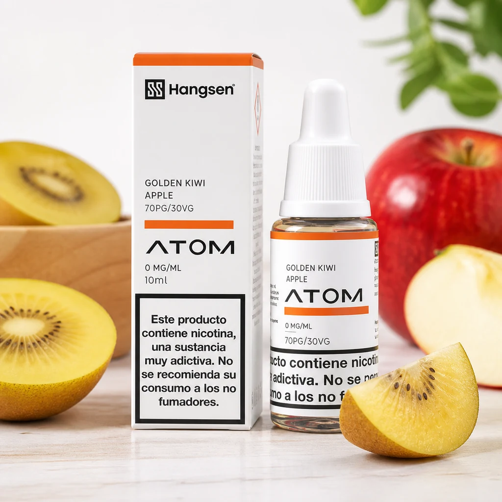 Frasco y caja de Hangsen Atom Golden Kiwi Apple con etiqueta de 0 mg/ml, rodeados de kiwi amarillo y manzana.