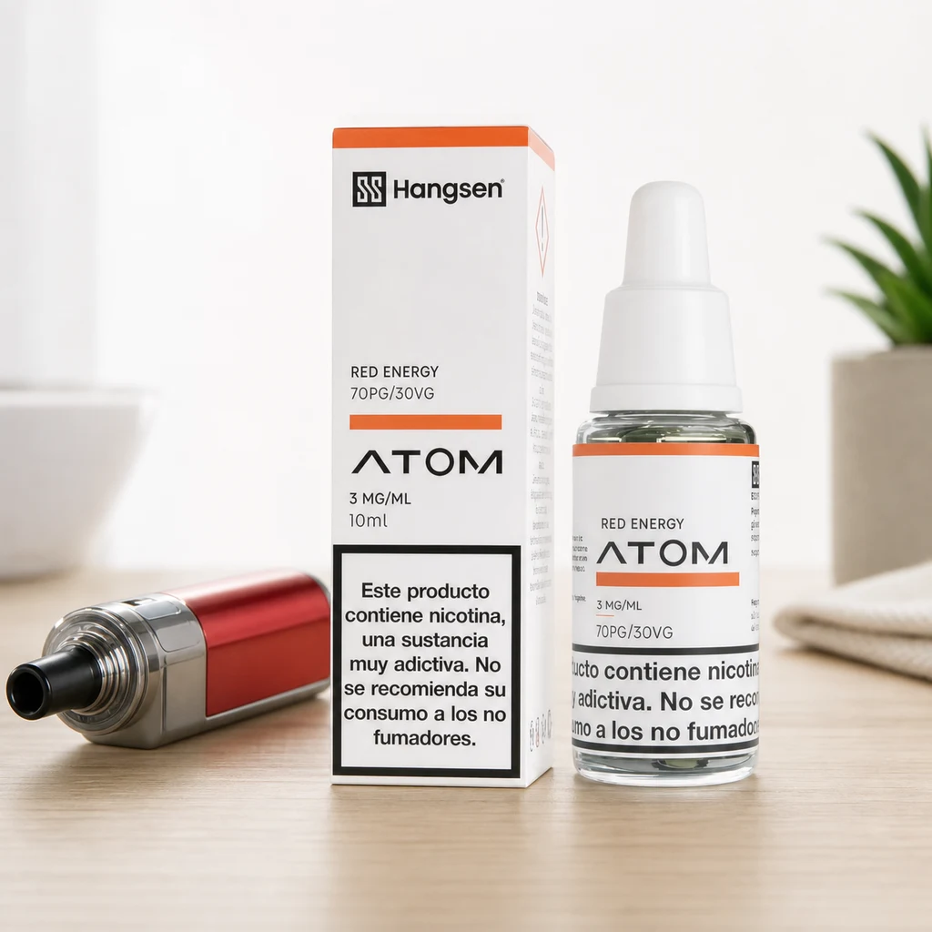 Frasco y caja de Hangsen Atom Red Energy con advertencia de nicotina, junto a un vapeador rojo sobre una mesa.
