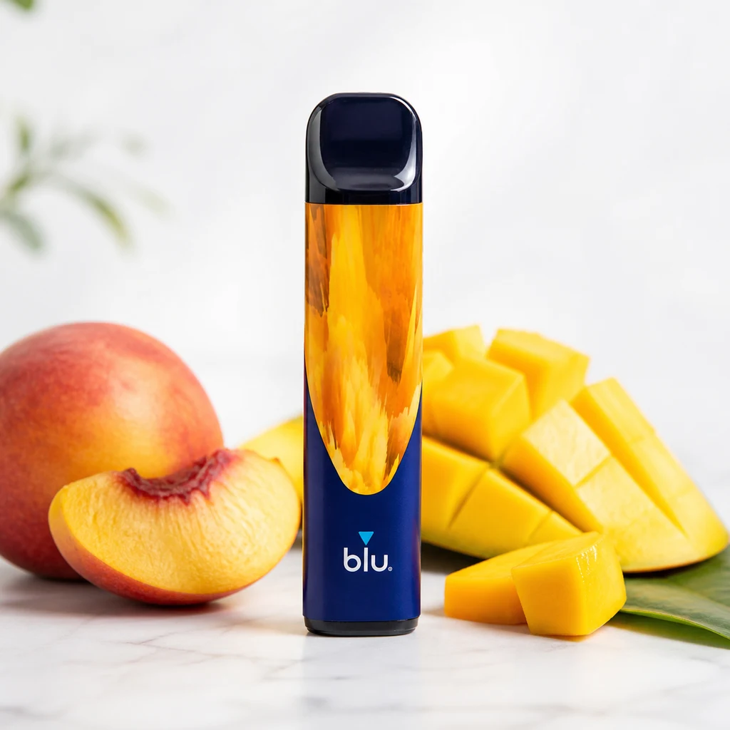 Blu Bar Tropical Mix 1000 en vertical, con cuerpo azul y naranja y boquilla oscura, junto a melocotón y mango cortados.