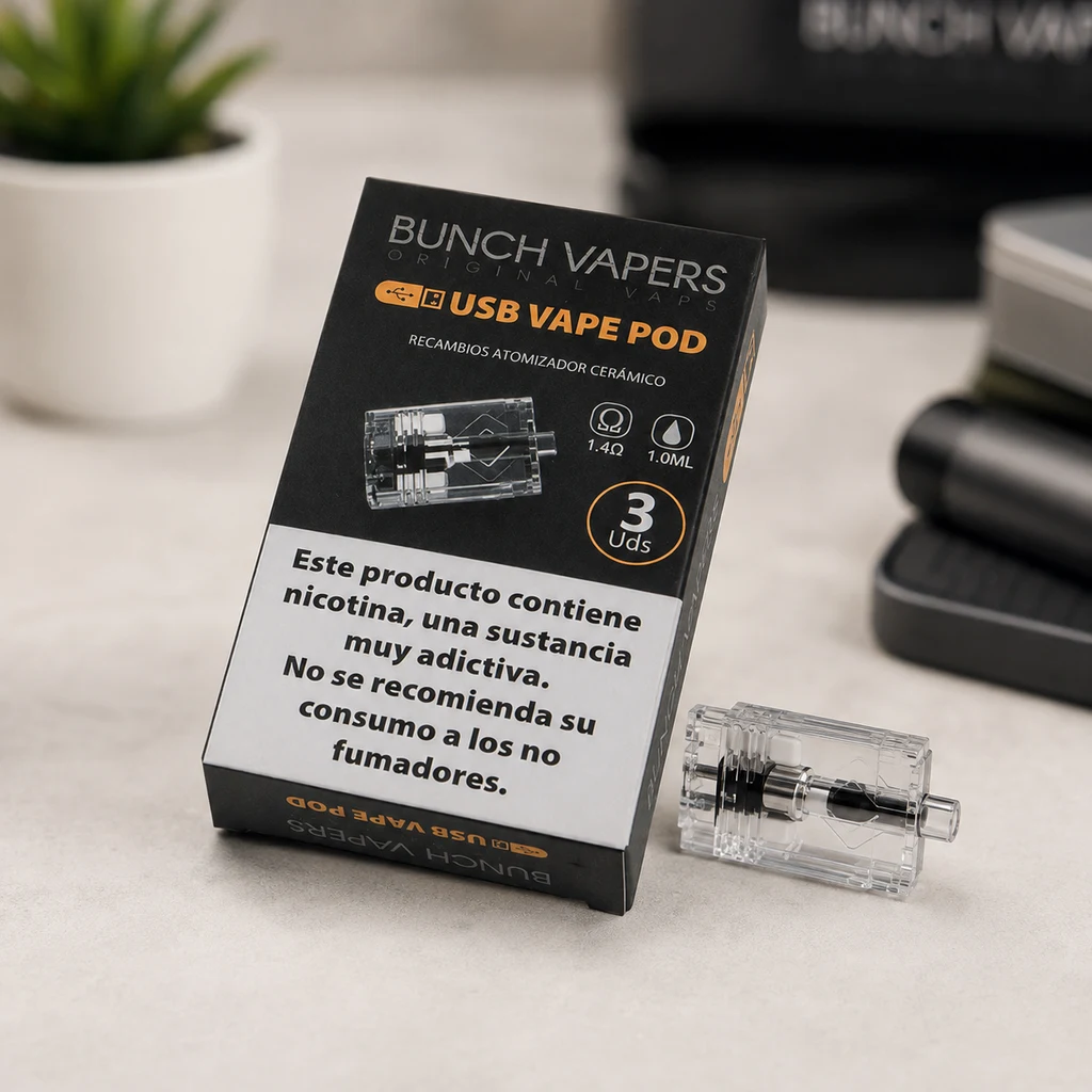 Caja negra Bunch Vapers USB Vape Pod con indicaciones de 1,4 Ω y 1,0 ml, junto a un recambio transparente tumbado sobre la mesa.