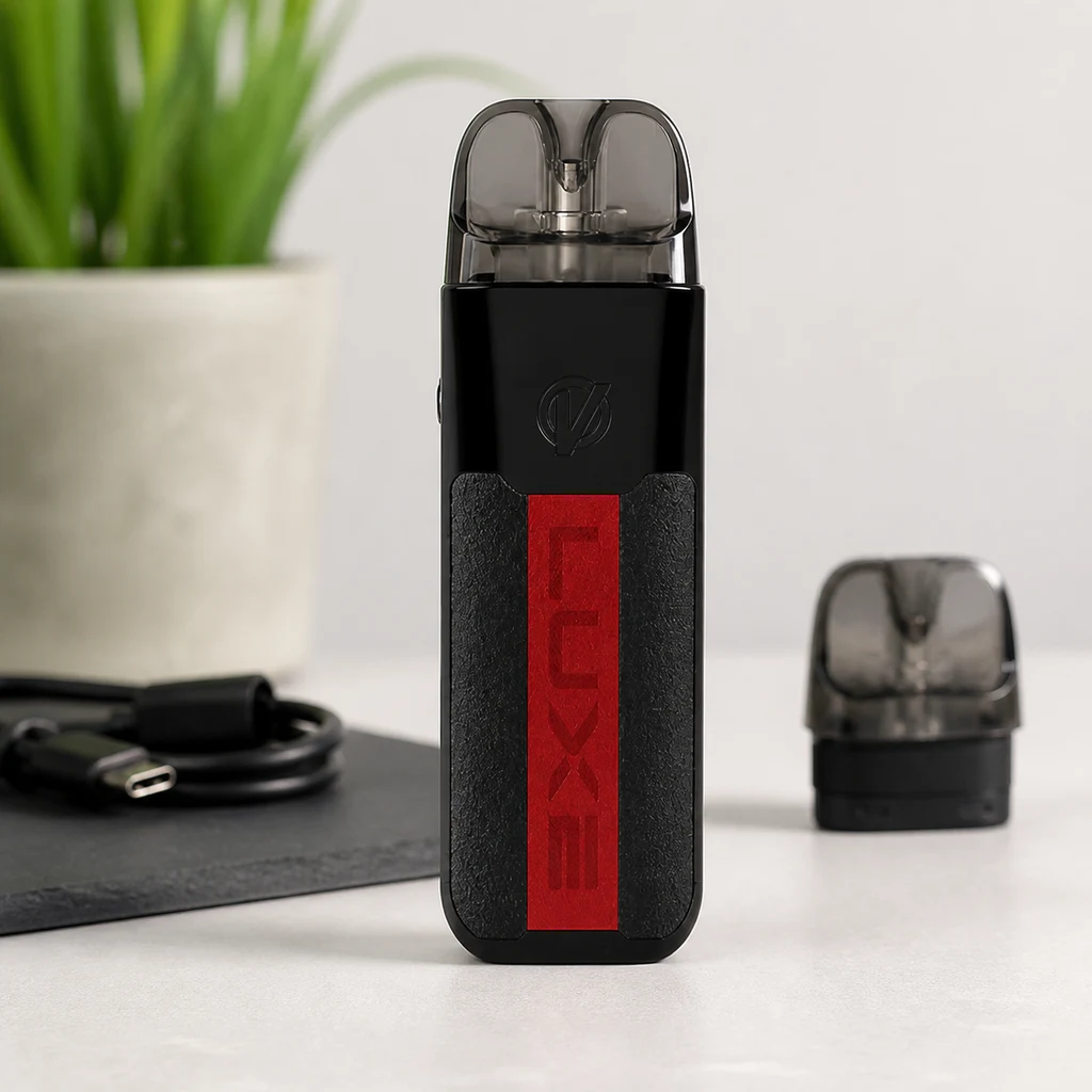 Vaper Vaporesso Luxe XR Max negro con franja roja y depósito translúcido, de pie junto a un cartucho separado y un cable USB.